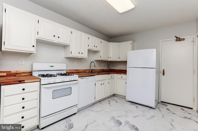 kitchen featuring sink, wood counters, a textured ceiling, white appliances, and white cabinets