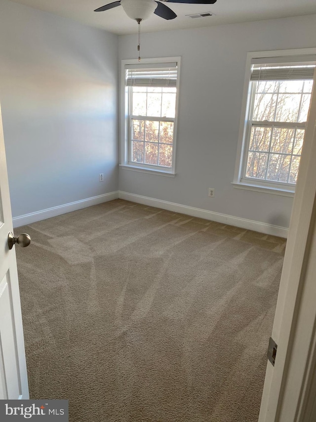 carpeted empty room with ceiling fan