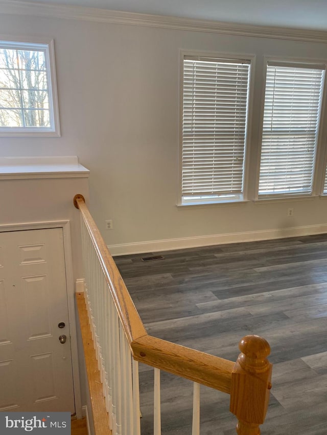 stairs with hardwood / wood-style floors and ornamental molding