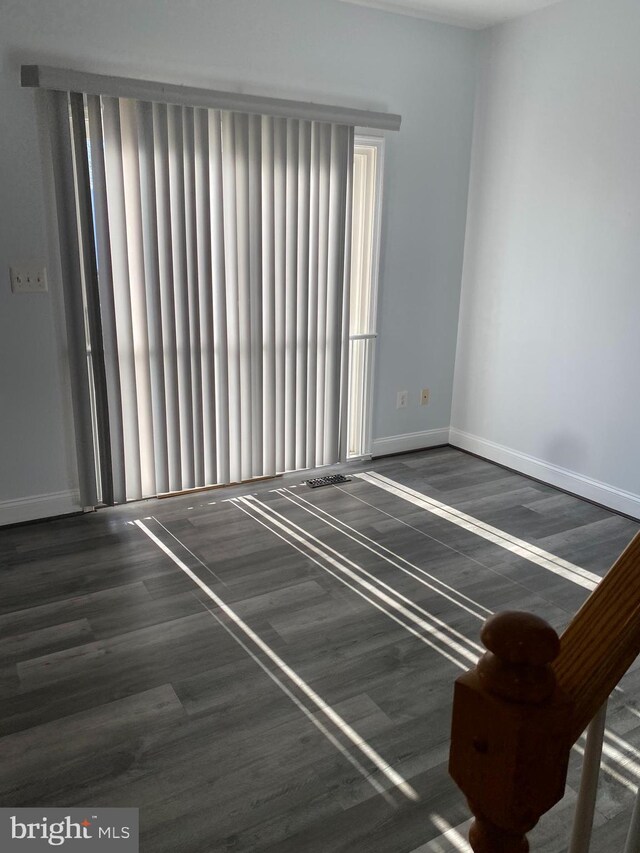 unfurnished room featuring dark hardwood / wood-style flooring