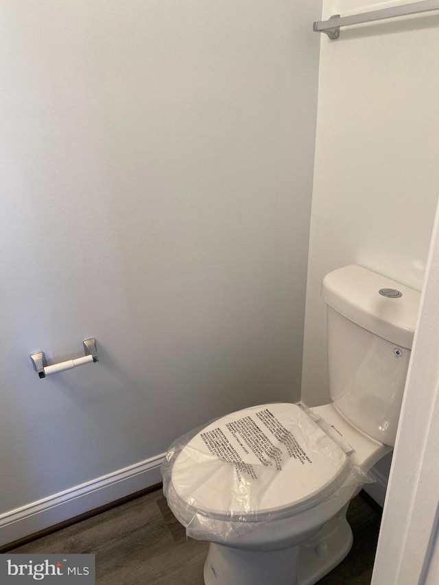 bathroom featuring hardwood / wood-style floors and toilet