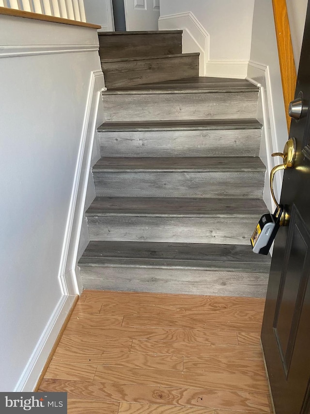 stairs featuring hardwood / wood-style flooring