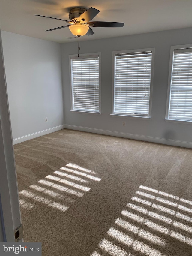 empty room with carpet and ceiling fan