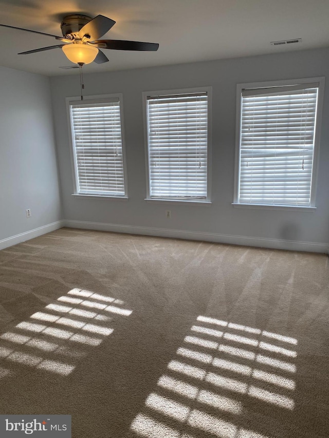 spare room with carpet and ceiling fan