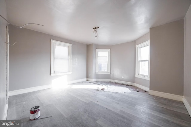 spare room featuring hardwood / wood-style floors and a wealth of natural light