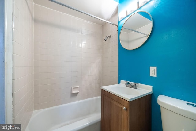 full bathroom featuring vanity, toilet, and tiled shower / bath