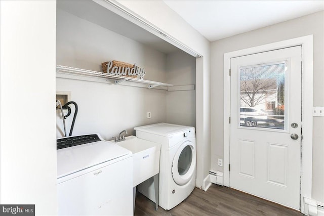 laundry room with separate washer and dryer, dark wood-type flooring, and a baseboard heating unit