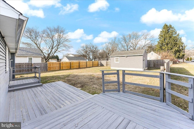 wooden terrace with a lawn and a shed