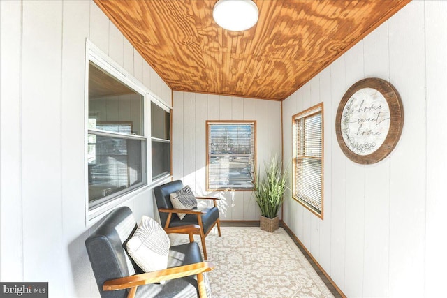 interior space with wooden ceiling, wooden walls, and vaulted ceiling