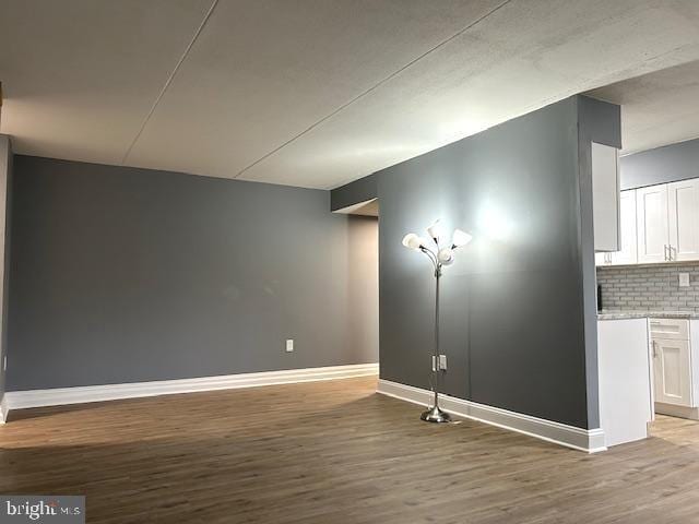 basement with hardwood / wood-style floors