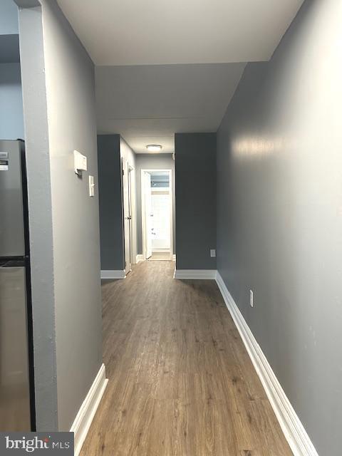 corridor featuring hardwood / wood-style floors