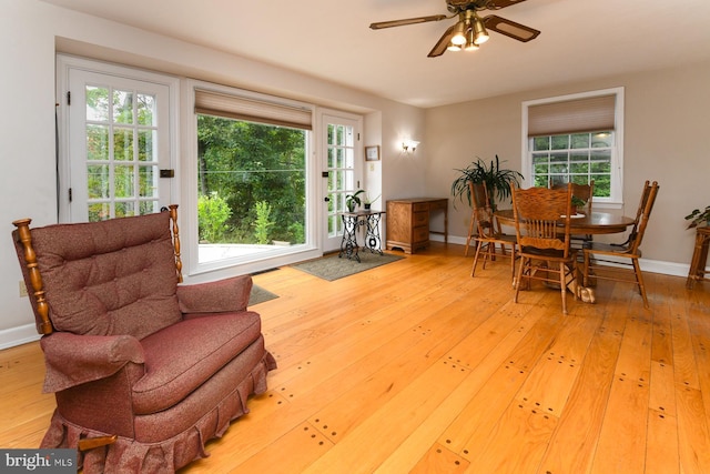 sitting room featuring ceiling fan and light wood-type flooring