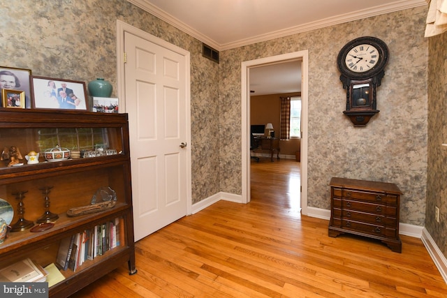 hallway featuring light wood-type flooring and crown molding