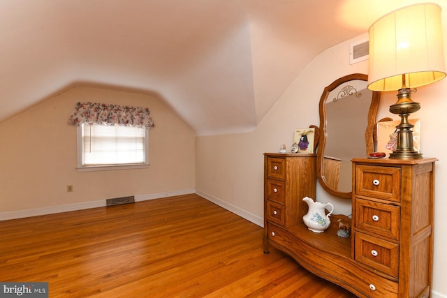 bonus room with vaulted ceiling and light hardwood / wood-style flooring