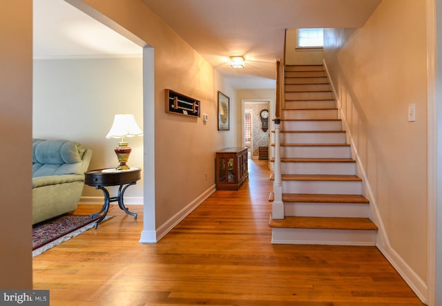 staircase with hardwood / wood-style floors