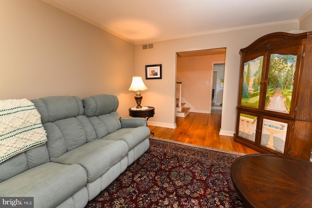 living room featuring light hardwood / wood-style floors and ornamental molding