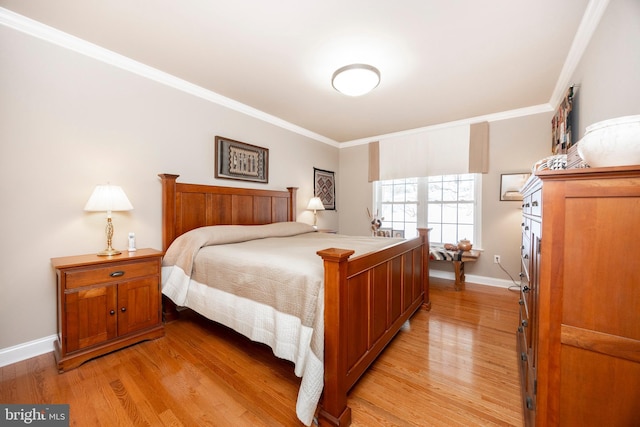 bedroom featuring ornamental molding and light hardwood / wood-style flooring