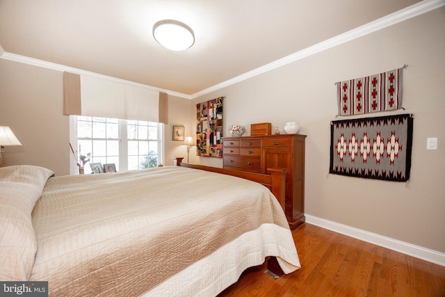 bedroom with hardwood / wood-style flooring and crown molding