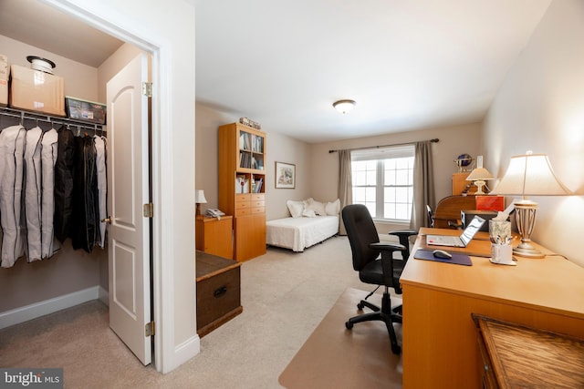 bedroom with light colored carpet and a closet