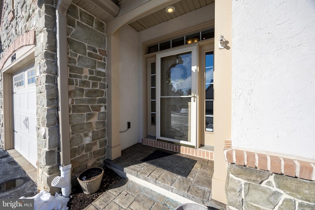 view of exterior entry featuring a garage