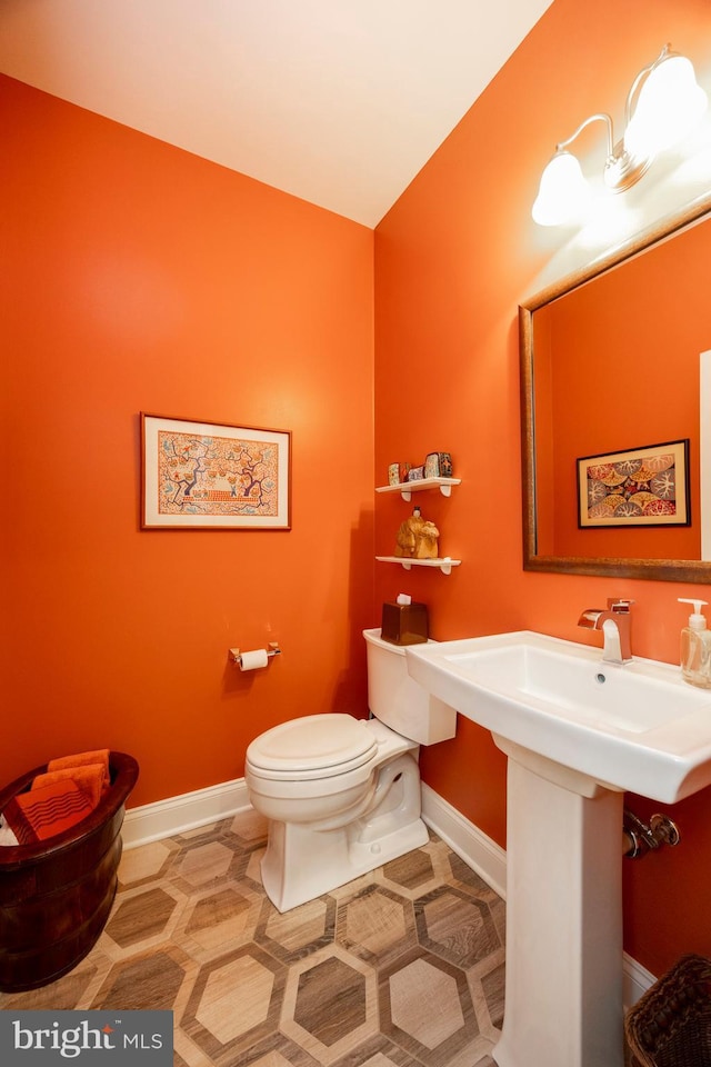 bathroom with toilet and tile patterned flooring