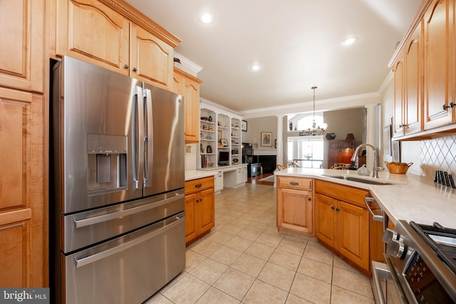 kitchen with sink, an inviting chandelier, decorative light fixtures, ornamental molding, and appliances with stainless steel finishes