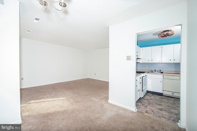 kitchen with decorative backsplash, carpet flooring, white appliances, sink, and white cabinetry