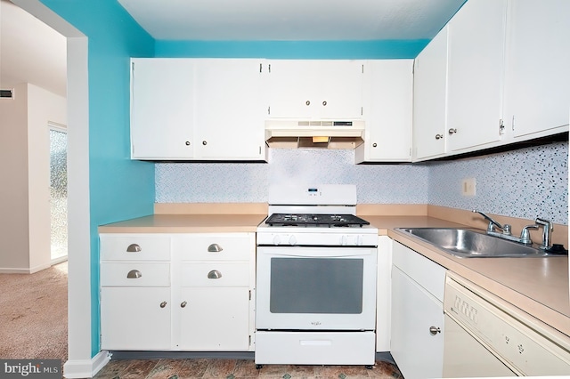 kitchen featuring white appliances, dark colored carpet, sink, decorative backsplash, and white cabinetry