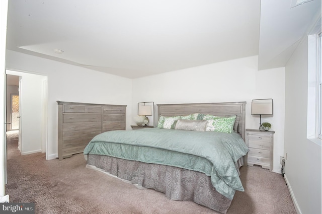 bedroom featuring light colored carpet