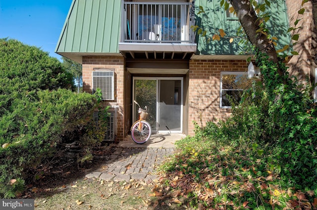 rear view of property with a balcony and cooling unit