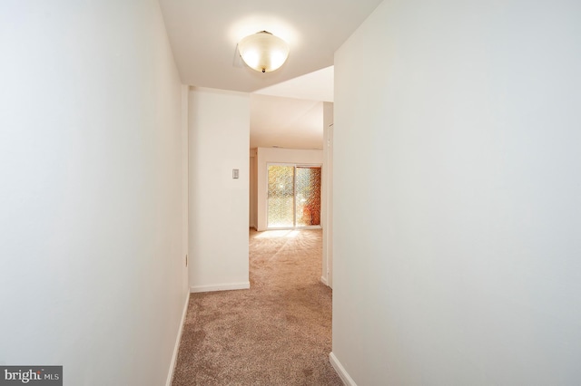 hall with light colored carpet