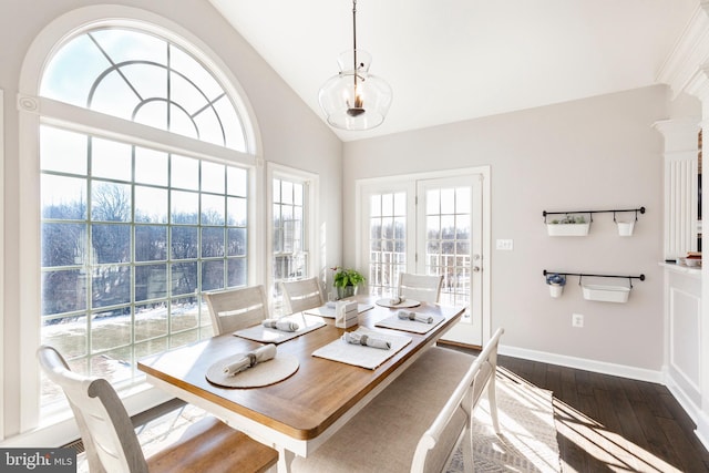 dining room with vaulted ceiling and dark hardwood / wood-style floors