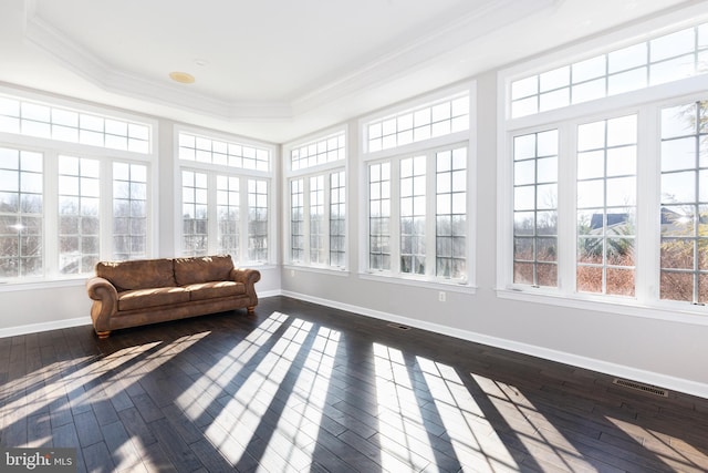 sunroom / solarium with a raised ceiling