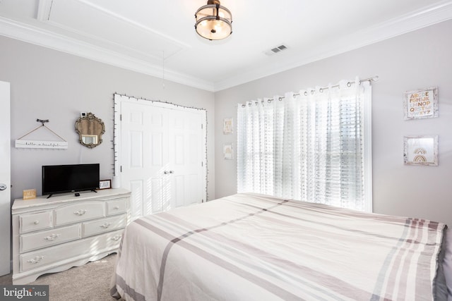 carpeted bedroom featuring ornamental molding and a closet