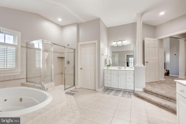 bathroom with tile patterned flooring, shower with separate bathtub, vanity, and ornate columns