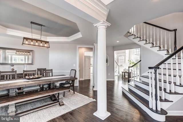 dining room featuring crown molding, a wealth of natural light, dark hardwood / wood-style floors, and a tray ceiling