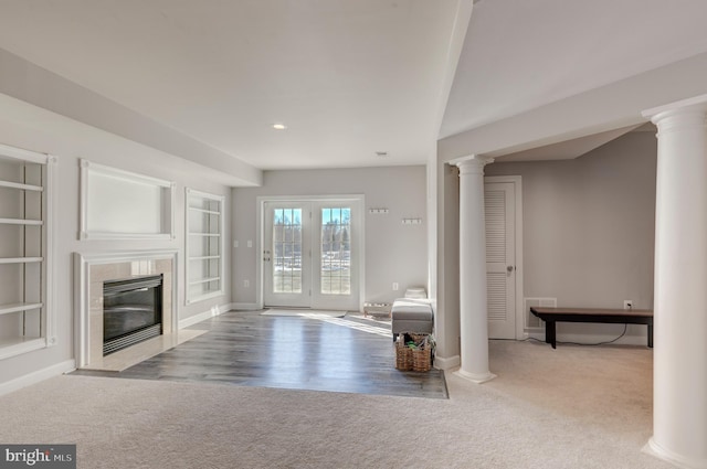 unfurnished living room with built in features and light carpet