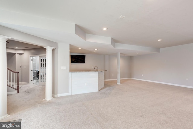 unfurnished living room featuring french doors and light carpet