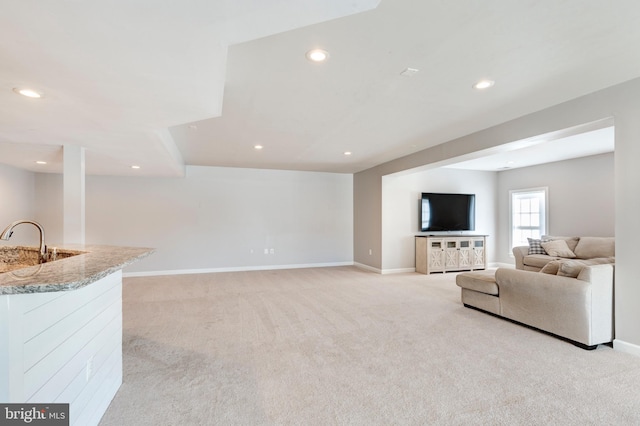 living room featuring sink and light carpet