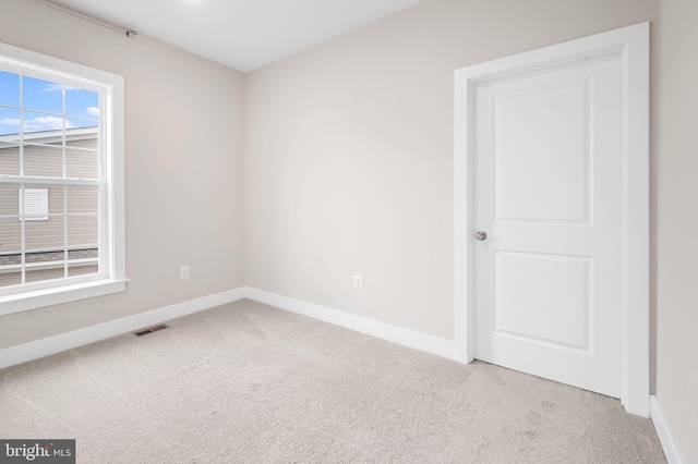 empty room featuring light carpet