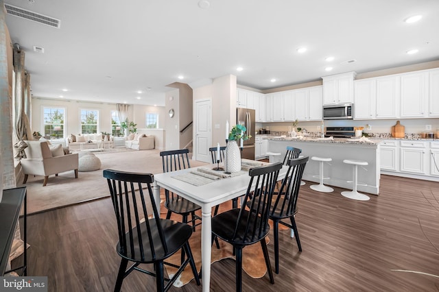 dining space with dark hardwood / wood-style flooring