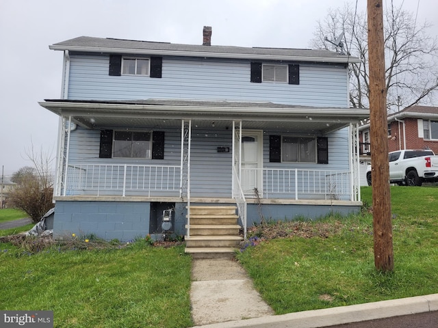 view of front facade with covered porch and a front yard