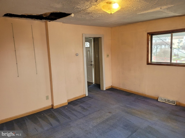 11 Green St, Frostburg, MD 21532 - spare room featuring a textured ceiling and dark colored carpet
