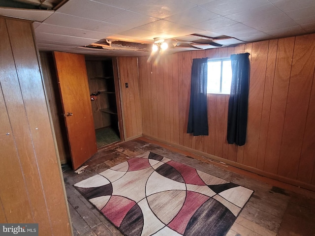 11 Green St, Frostburg, MD 21532 - unfurnished bedroom featuring dark hardwood / wood-style flooring, a closet, and wood walls