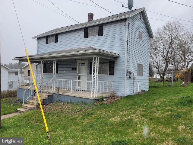 view of front of property with a front lawn and covered porch