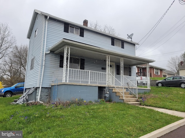 view of front of home featuring covered porch and a front lawn