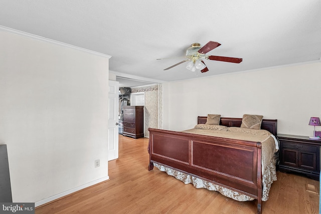 bedroom with ceiling fan, light wood-type flooring, and crown molding