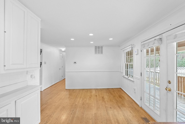 spare room with crown molding and light hardwood / wood-style floors