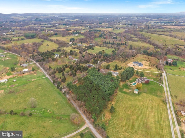 birds eye view of property with a rural view