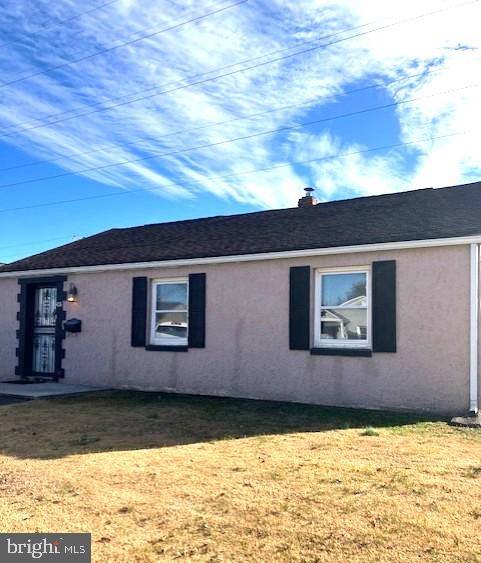 view of property exterior with a lawn